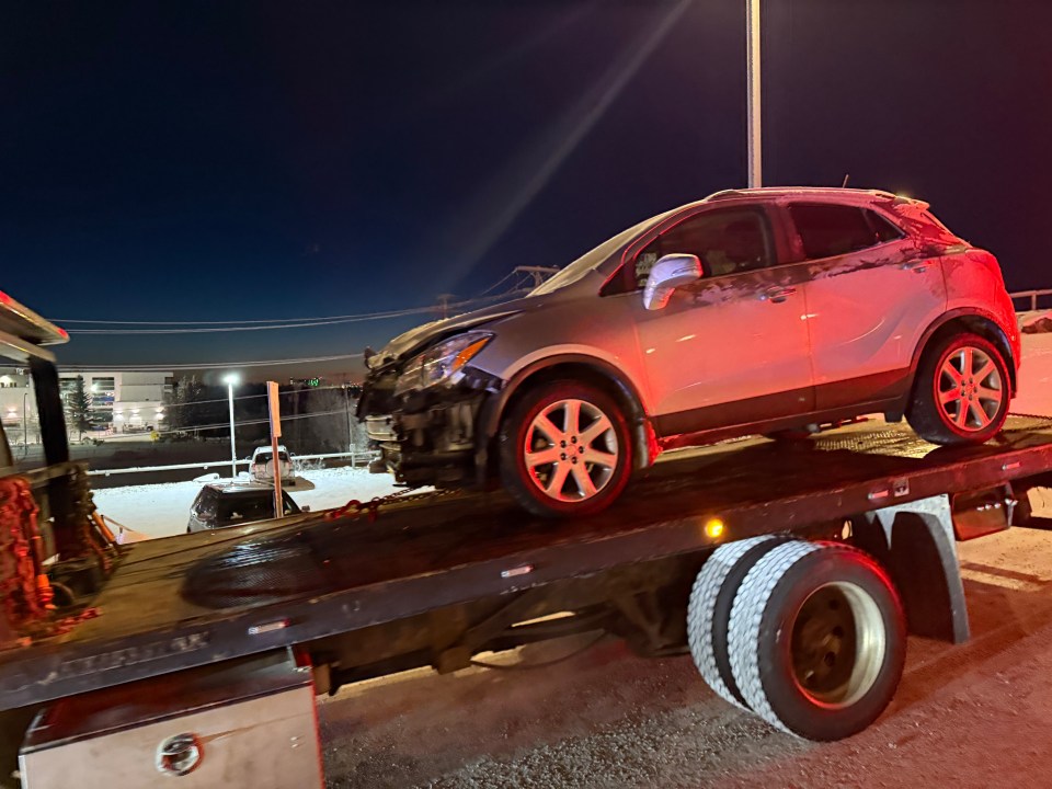 A damaged car is transported from the Explorer Hotel after crashing into its foyer. Ollie Williams/Cabin Radio