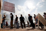 Voters line up at a polling site to vote in the state's primary election at Allen Municipal...