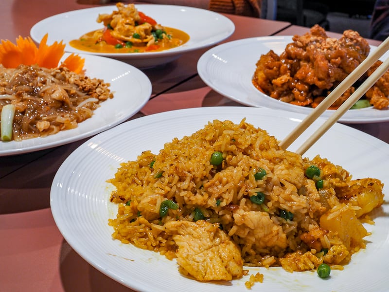 Four dishes of Thai food with chopsticks at Bangkok Thai restaurant in Liverpool, New York