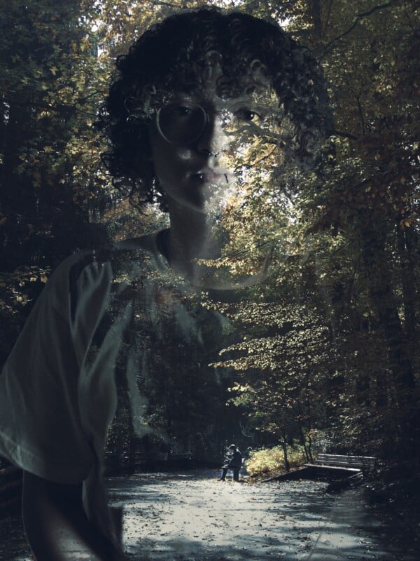 A double exposure image blending a close-up of a person with curly hair and glasses over a sunlit, tree-lined path where two people walk in the distance.