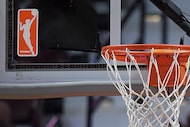 FILE - The WNBA logo is seen near a hoop before an WNBA basketball game at Mohegan Sun...