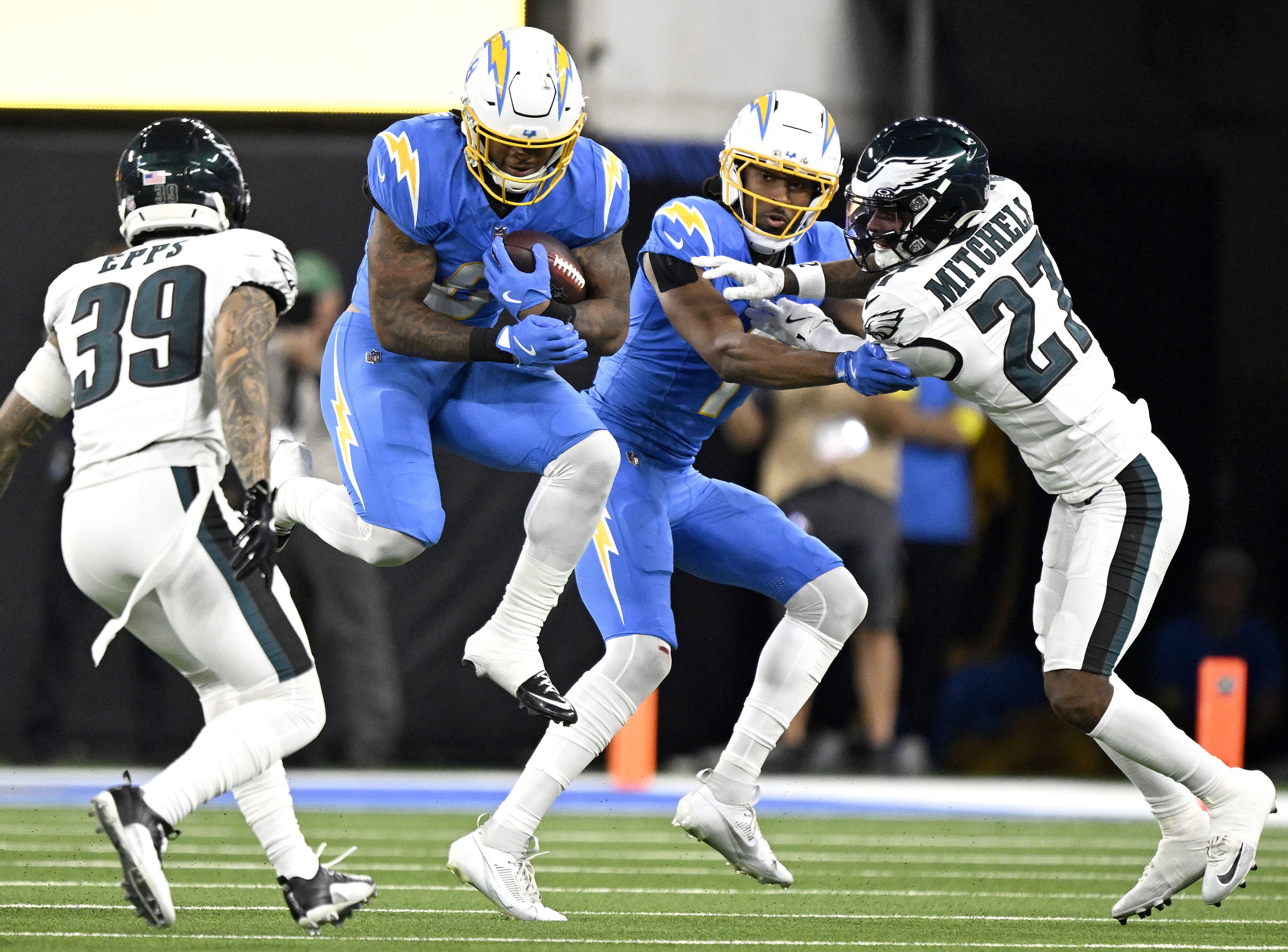 Chargers running back Omarion Hampton (8) leaps as he finds...