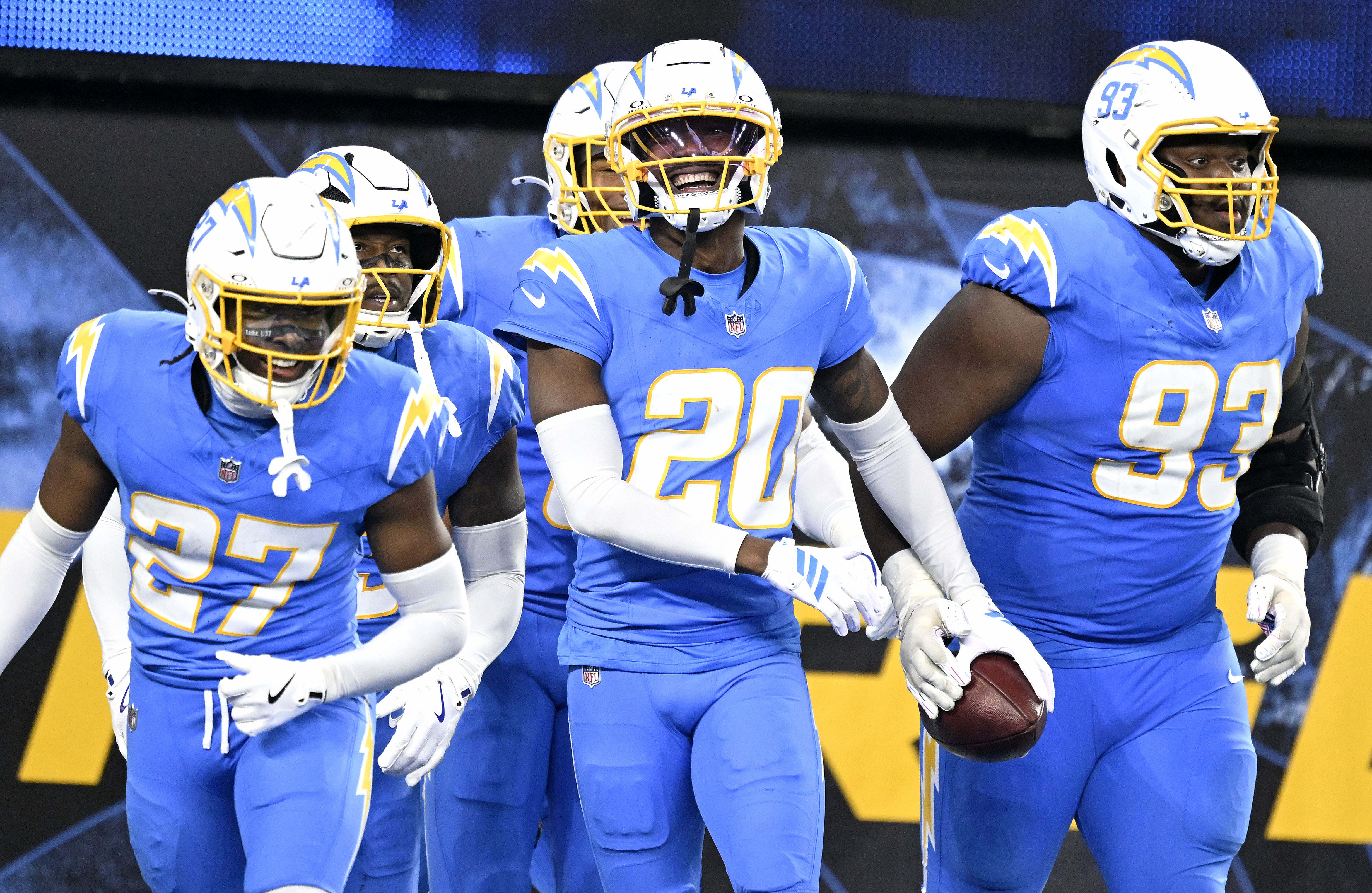 Chargers cornerback Cam Hart (20) celebrates with teammates after his...