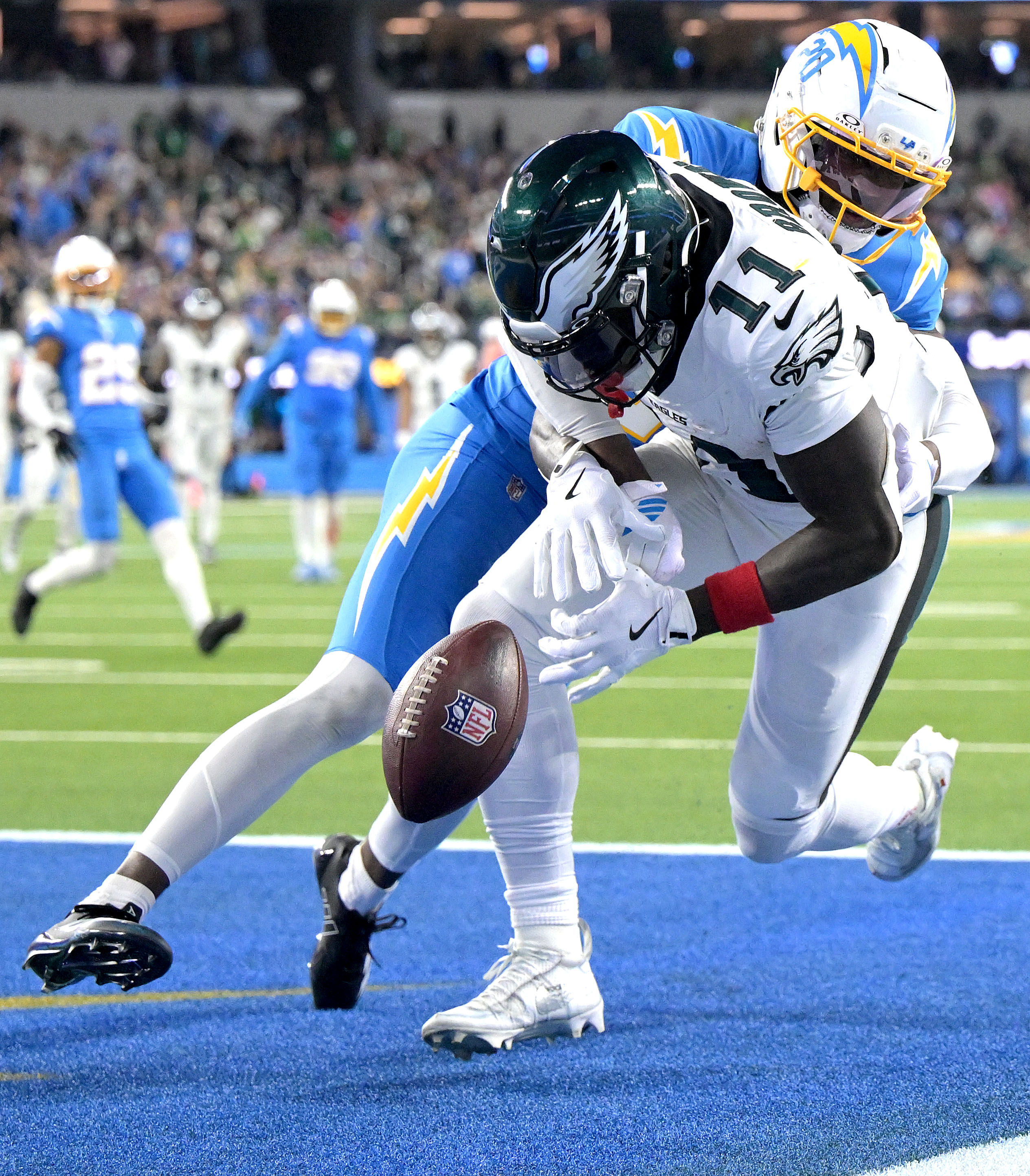 Chargers cornerback Cam Hart, top, defends as Philadelphia Eagles wide...