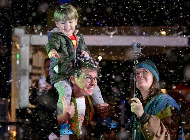 A youngster enjoys the fake snow. The Los Angeles Music...