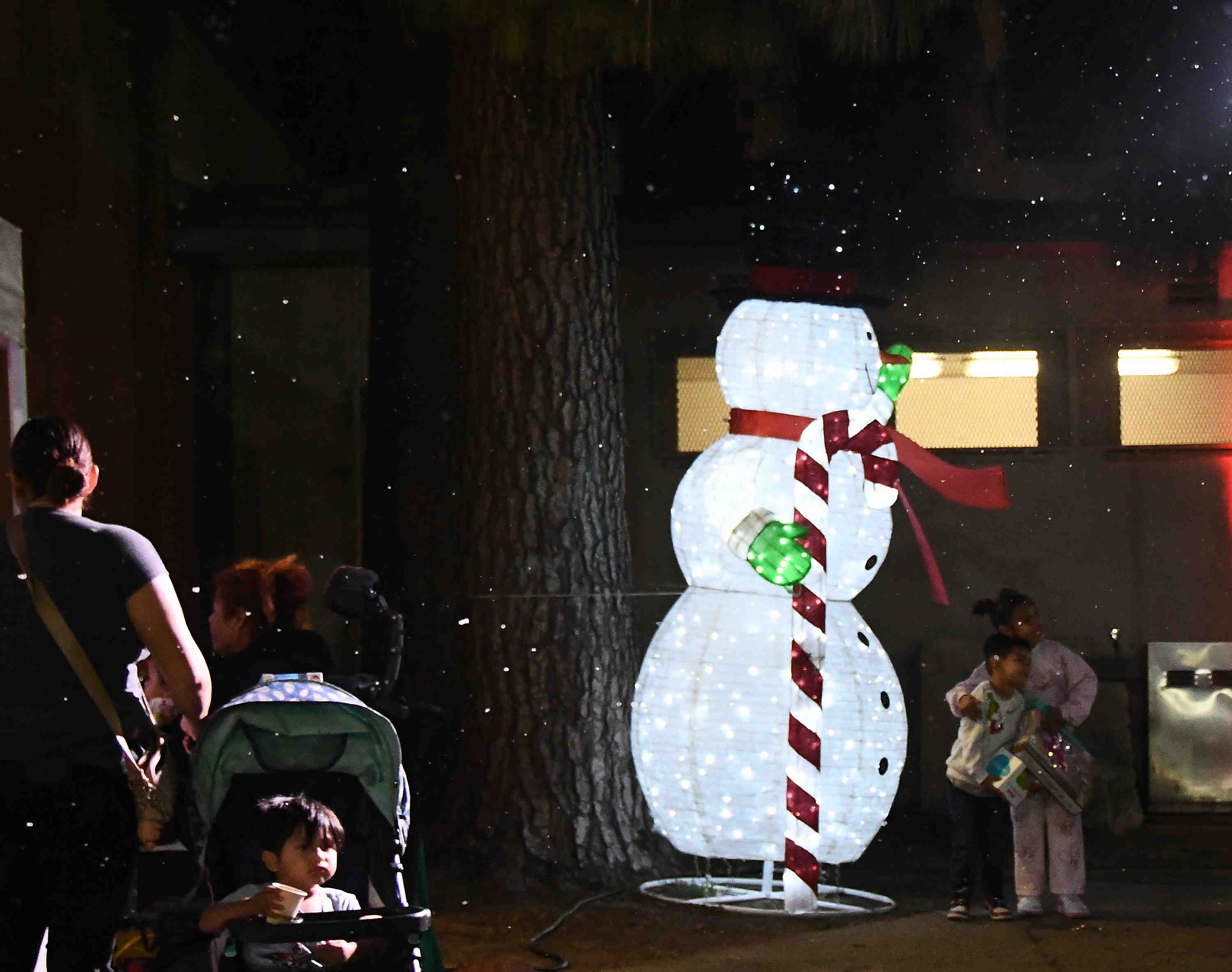 “Snow” falls as kids get photos with Frosty the Snowman...