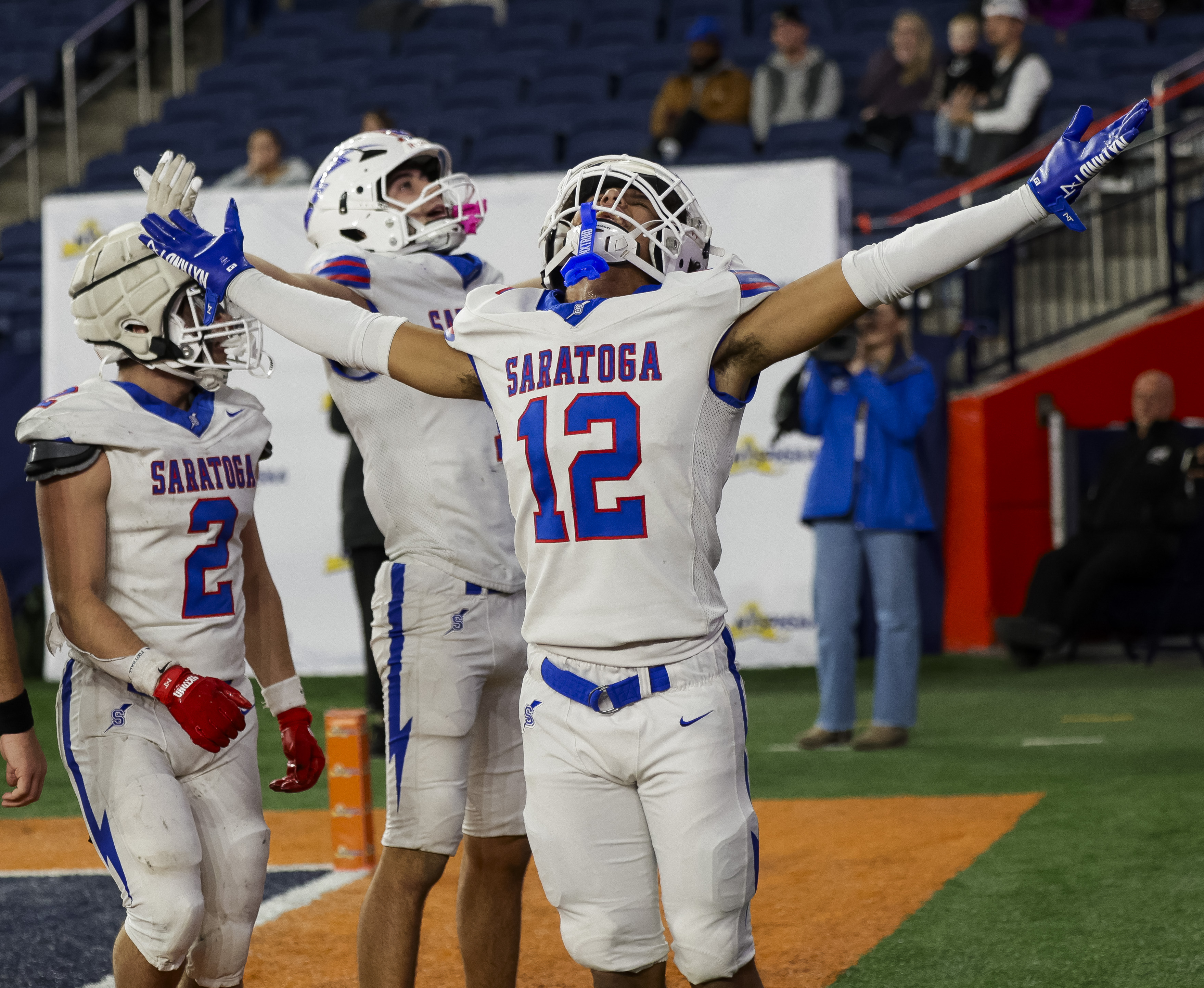 Saratoga Springs Blue Streaks Jaden Lockrow (12) celebrates a touchdown as the CBA Brothers and Saratoga Springs Blue Streaks fought for the New York State Class AA state title at JMA Wireless Dome Saturday, December 6, 2025. (N. Scott Trimble | strimble@syracuse.com)
