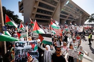 People leave Dallas City Hall and march through downtown Dallas during the “Save Gaza Mega...