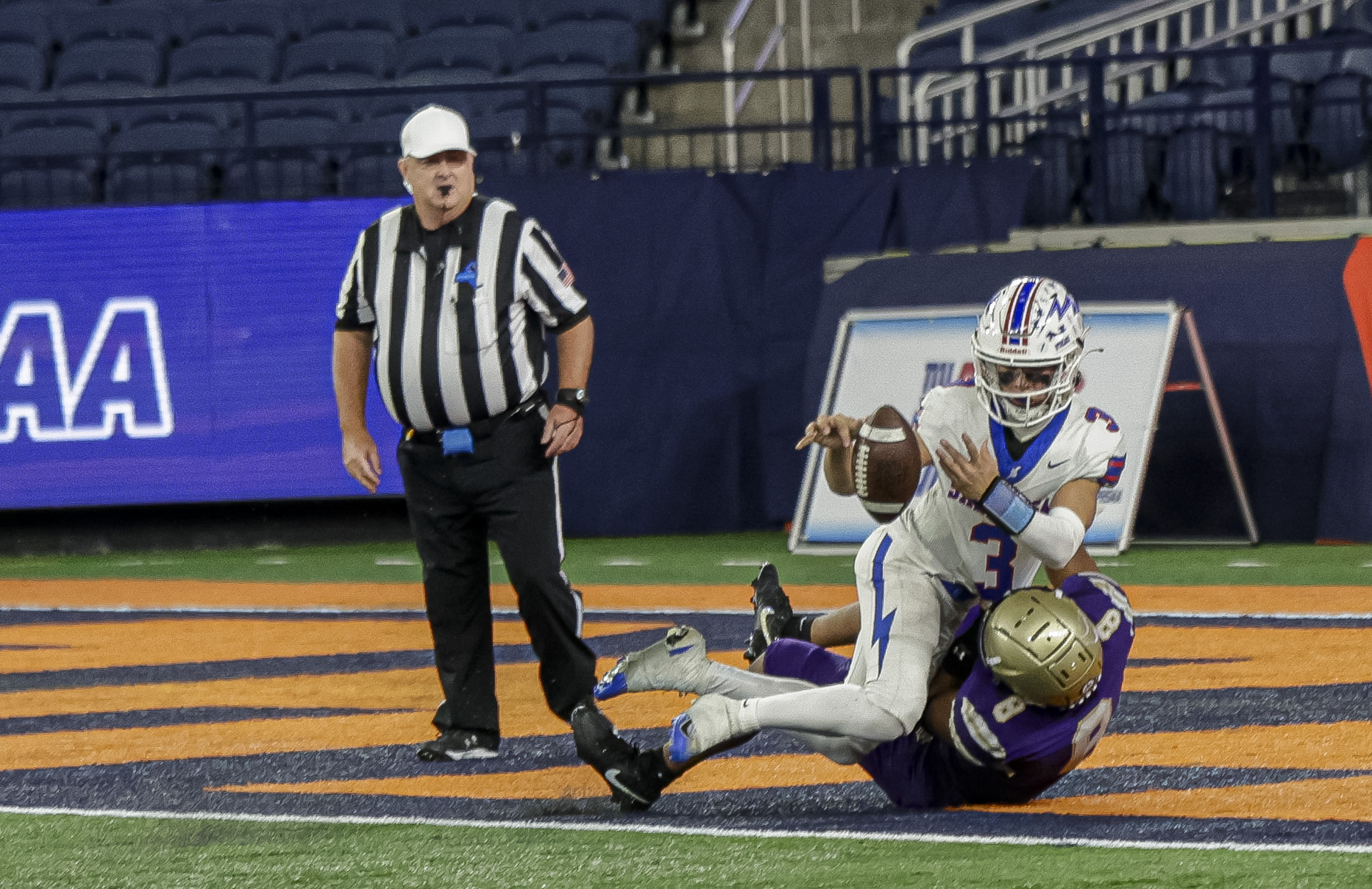 Quarterback Saratoga Springs Blue Streaks Robert Morris (3) gets tackled in the end zone by CBA Brothers linebacker Jhadon Gary (8) as the CBA Brothers and Saratoga Springs Blue Streaks fought for the New York State Class AA state title at JMA Wireless Dome Saturday, December 6, 2025. (N. Scott Trimble | strimble@syracuse.com)