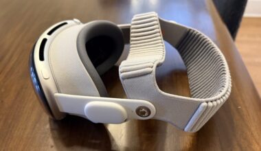 A headset sits on a wood table