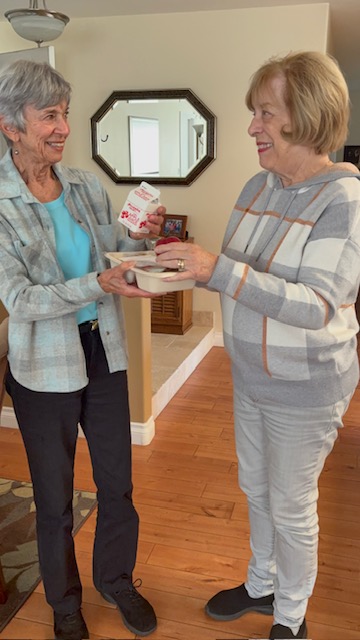 Client Judy Porter (left) poses with the millionth meal delivered by La Jolla Meals on Wheels with volunteer Sharon Thibeault. (La Jolla Meals on Wheels)