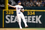 Texas Rangers shortstop Josh Smith (8) throws to first during the fifth inning of a baseball...