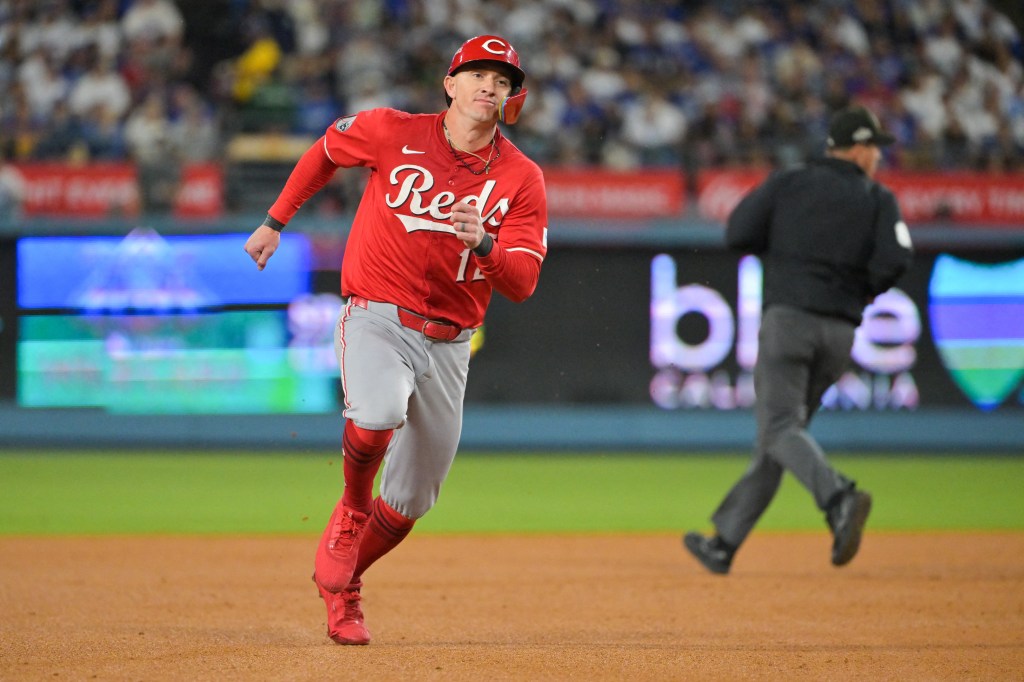 Cincinnati Reds left fielder Austin Hays (12) advances to third base on a single from Cincinnati Reds first baseman Spencer Steer (7) (not pictured) during the seventh inning against the Los Angeles Dodgers during game one of the Wildcard round for the 2025 MLB playoffs at Dodger Stadium. 