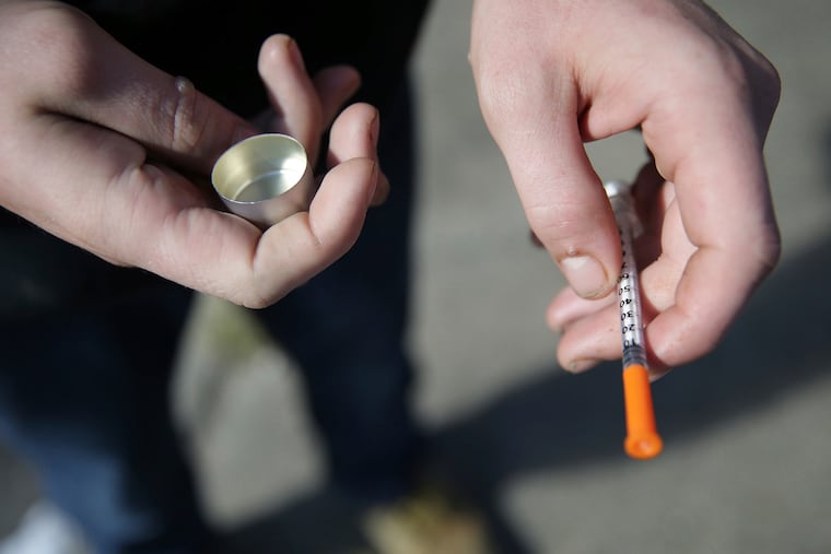 In this Oct. 22, 2018 file photo, a fentanyl user holds a needle near Kensington and Cambria in Philadelphia. Overdose deaths decreased in Philadelphia and statewide in 2024 and are on track to drop again in 2025.