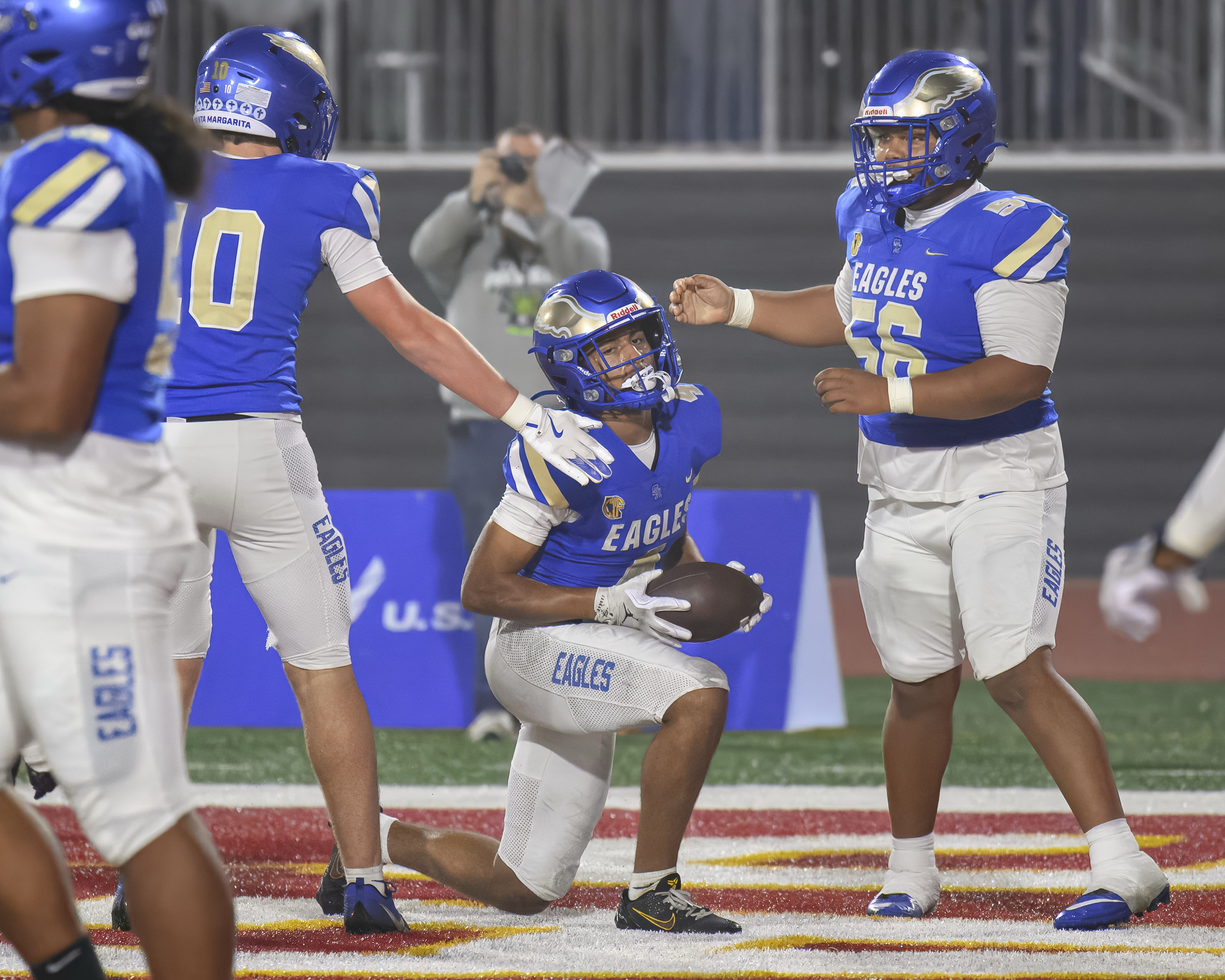Santa Margarita wide receiver Trent Mosley, center, is congratulated by...