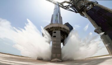 A view of SpaceX's starship system on the launchpad with the water-cooling flame deflector system active