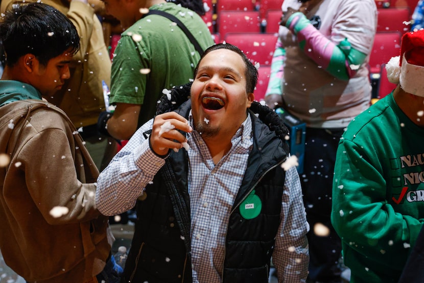 Student Ever Valerio looks in awe at the fake snow during Operation Officer Claus at...