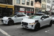 Waymo vehicles wait at an intersection in San Francisco, Wednesday, Oct. 22, 2025. (AP...
