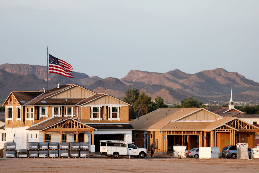 An American flag flies near new home construction at a housing development in Queen Creek.