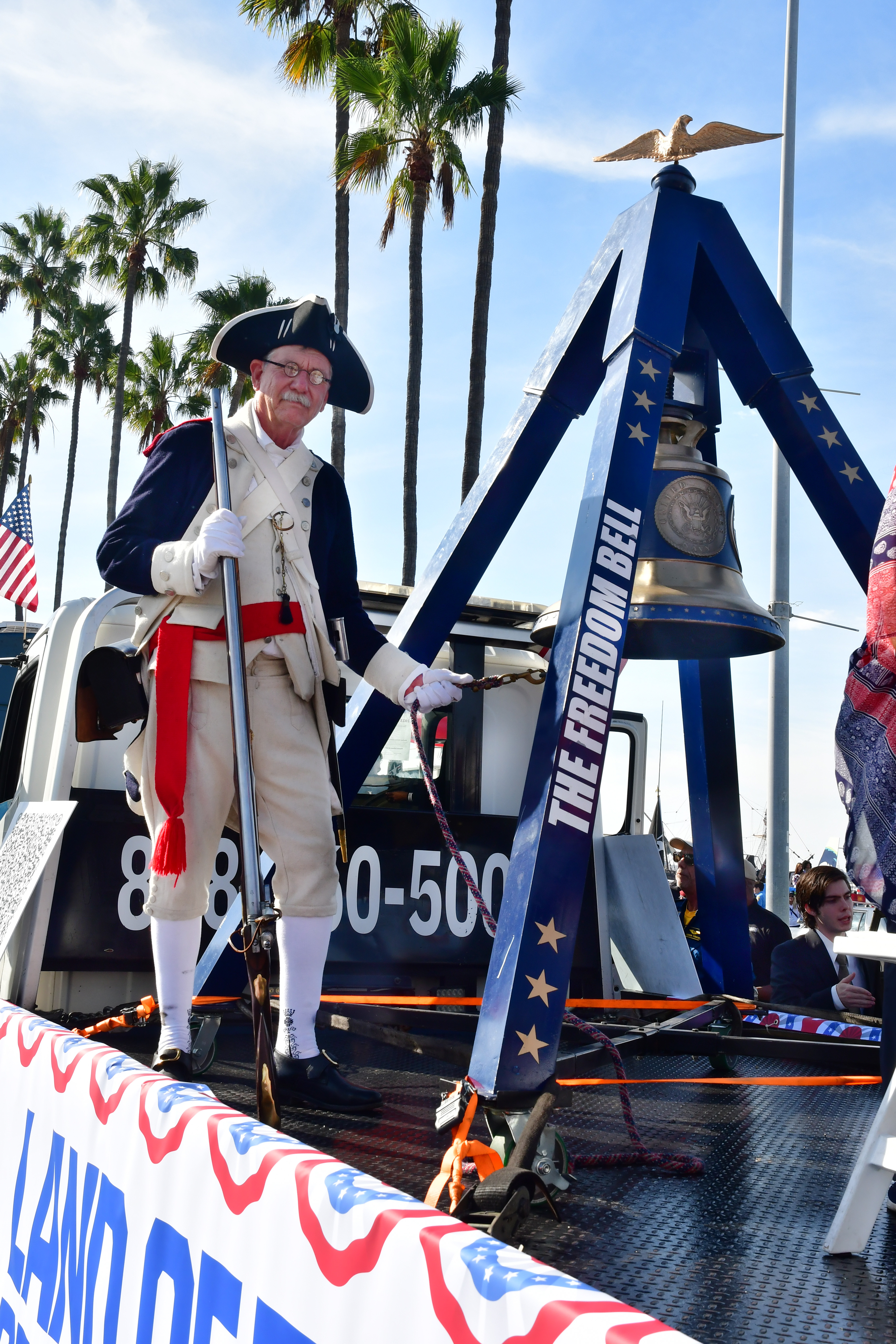 Member of the Sons of the American Revolution ringing the...