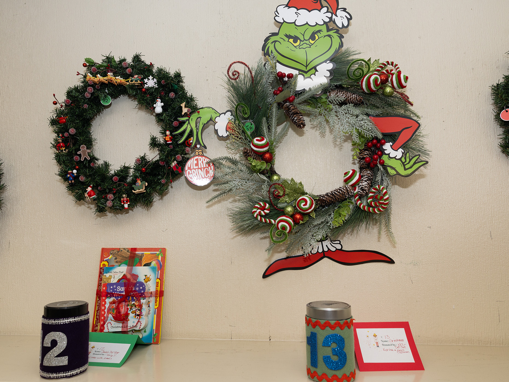 “Santa’s Toy Shop” wreath by Terry S., “Grinchmas” wreath by...