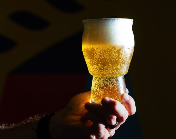 A glass of Upside Dawn Golden at the Athletic Brew Company, in Miramar, Tuesday Nov. 11, 2025, in San Diego, California. Their beers are non-alcoholic with less than 0.5% of alcohol by volume. Howard Lipin / For The San Diego Union-Tribune....NOTE: No sign on the outside of the building, as they're in what used to be the Ballast Point building, which still has the Ballast Point name on it. And not a lot of activity inside.