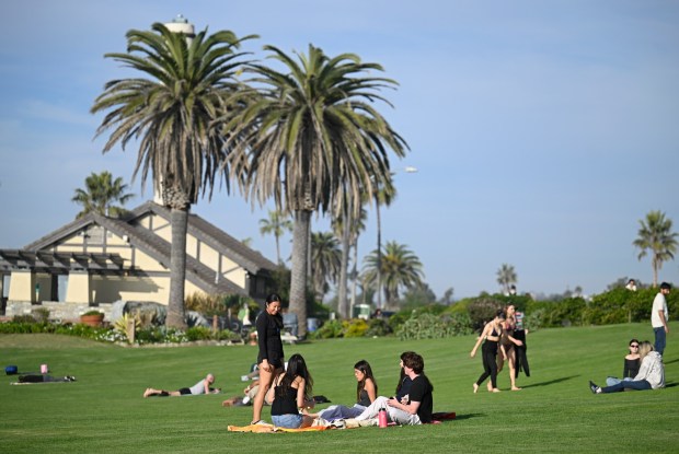 People enjoy the sunshine at Powerhouse Park, Dec.18, 2025 in Del Mar, Calif. (Photo by Denis Poroy)
