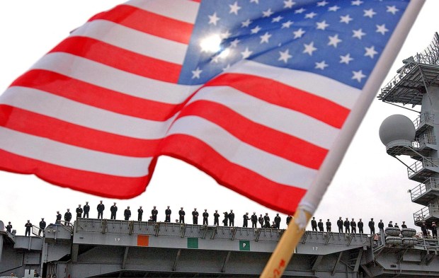 U.S. Navy sailors stand on the deck as they deploy with the aircraft carrier USS Nimitz from North Island Naval Station on 03 March, 2003, in San Diego, Califrornia. The Nimitz sailed from the US west coast for the Persian Gulf, leading a five-ship battle group carrying 8,000 sailors poised for war with Iraq. The nuclear-powered Nimitz, which will take at least a week to reach the theatre of a looming conflict aimed at toppling Iraqi leader Saddam Hussein, will be the sixth US carrier within striking distance of Iraq. AFP PHOTO/VINCE BUCCI (Photo by VINCE BUCCI / AFP) (Photo by VINCE BUCCI/AFP via Getty Images)