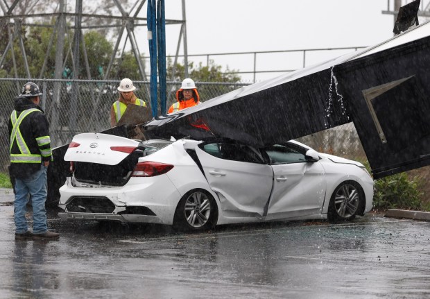 National City, CA - December 24: An advertising sign for Starbucks, Jersey Mike's Subs and Chipotle fell on a sedan and a van during a wind storm on December 24, 2025 in National City, CA. (K.C. Alfred / The San Diego Union-Tribune)