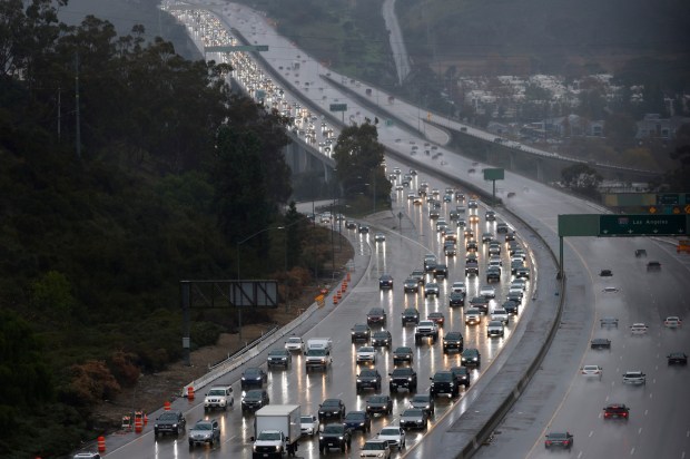 San Diego, CA - December 24: Traffic backs up on southbound I-805 in Mission Valley after after a series of accidents during a storm on December 24, 2025 in San Diego, CA. (K.C. Alfred / The San Diego Union-Tribune)
