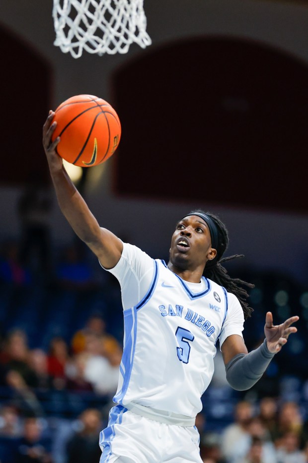 Ty-Laur Johnson #5 of San Diego goes up for a shot against USC during their game at the Jenny Craig Pavilion on Tuesday, Dec. 9, 2025 in San Diego, California. (Meg McLaughlin / The San Diego Union-Tribune)