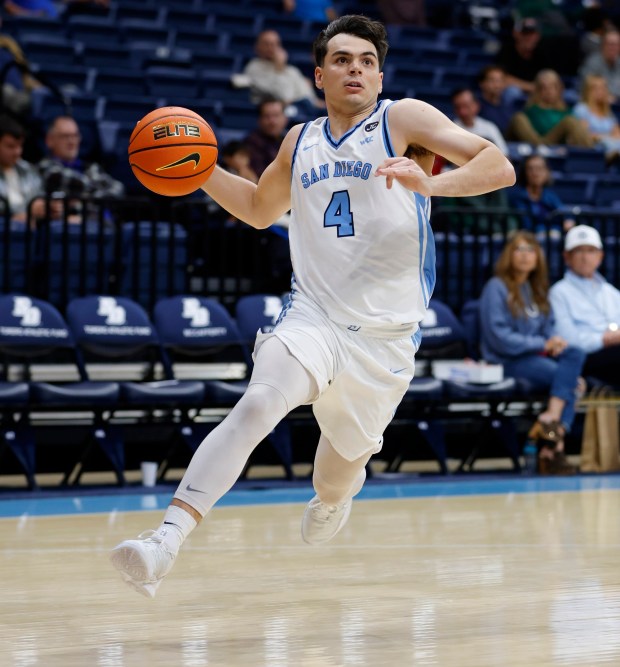 San Diego, CA - December 28: Juanse Gorosito #4 of University of San Diego drives in for a three point play against Pacific on December 28, 2025 in San Diego, CA. (K.C. Alfred / The San Diego Union-Tribune)