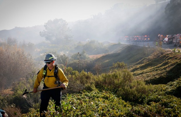 Firefighters battle a brushfire off Gilman Drive near UCSD on Thursday Jan. 23, 2025. (Sandy Huffaker / For The San Diego Union-Tribune)