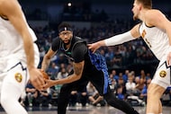 Dallas Mavericks forward Anthony Davis (3) keeps the ball away from Denver Nuggets center...