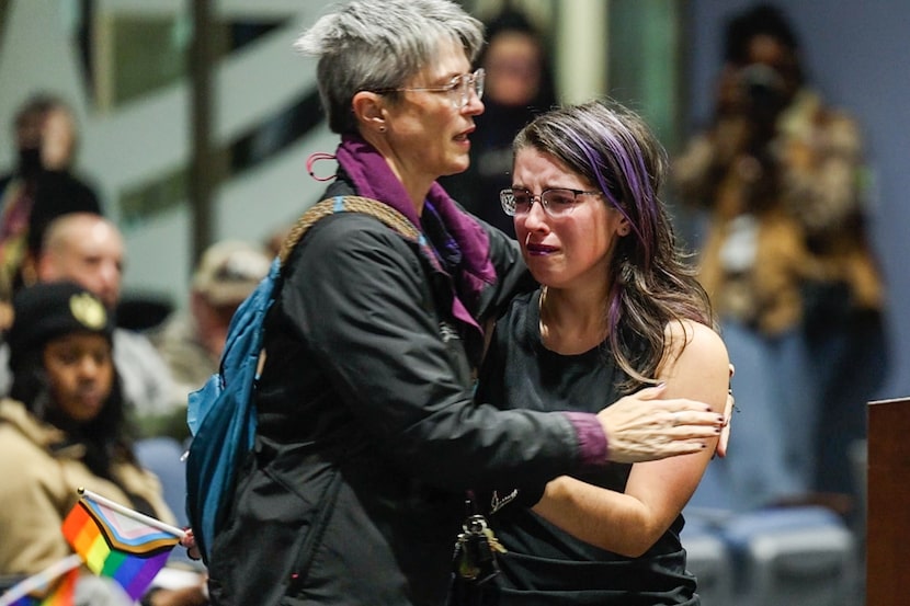 Arlington resident Kristin Rua, 49, comforts her daughter Elizabeth Rua, 15, after speaking...