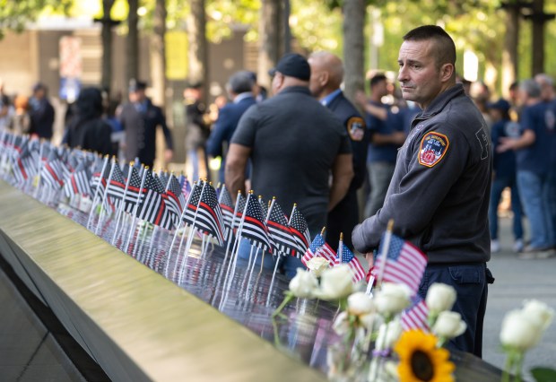 A FDNY firefighter takes in the 9/11 Memorial during the 24th anniversary 9/11 commemoration ceremony at Thursday, September 11, 2025 in New York, New York. (Barry Williams/ New York Daily News)