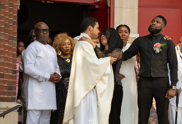 St. Helena Roman Catholic Church pastor Father Jorge Ramirez comforts River Wilson's mother Ima Wilson during her daughter's funeral at St. Helena Roman Catholic Church Wednesday, August 13, 2025 in Bronx, New York.(Barry Williams/ New York Daily News)