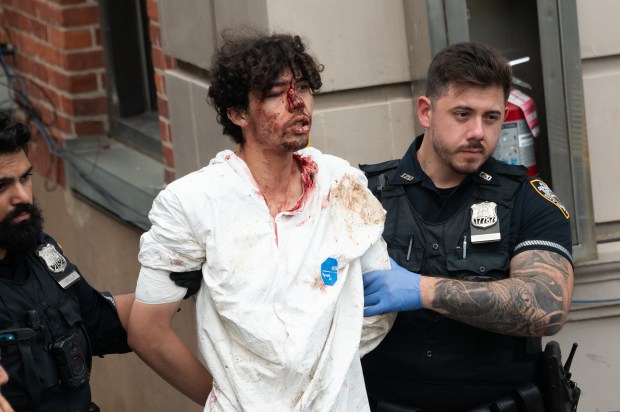Damien Hurstel is removed in an ambulance from the NYPD 120th Precinct station house in Staten Island, New York City on Tuesday, October 7, 2025. (Gardiner Anderson / New York Daily News)