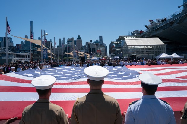 U.S. military personnel unveil a U.S. flag during the annual Memorial Day Ceremony at the Intrepid Museum Monday, May 26, 2025 in Manhattan, New York. (Barry Williams/ New York Daily News)