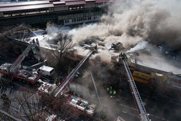 FDNY firefighters work a fire in multiple building at the corner of W. Burnside Ave. and Jerome Ave. on Thursday, Mar. 13, 2025. (Barry Williams/ New York Daily News)
