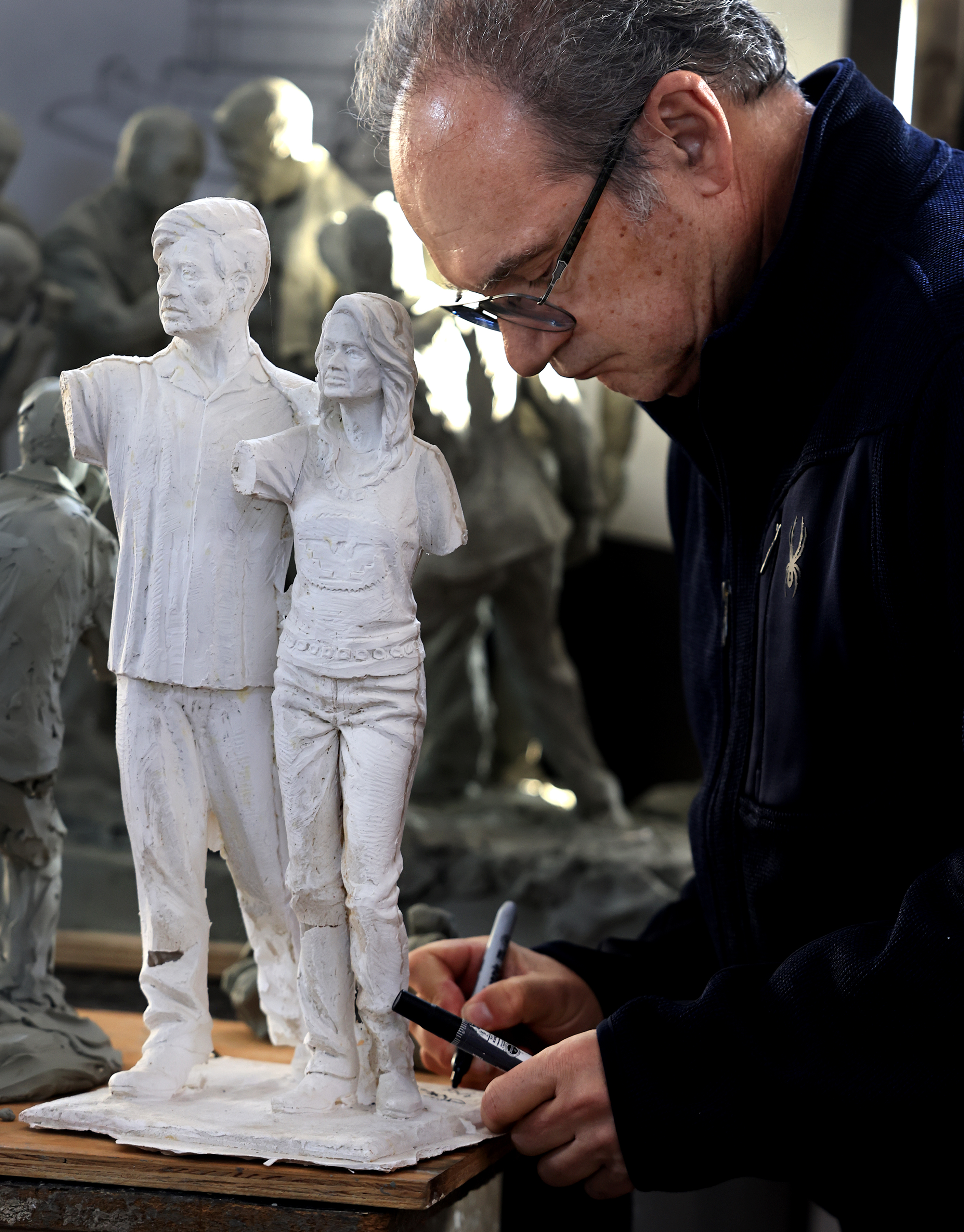 Artist Mario Chiodo signs the original artists proof of Cesar...