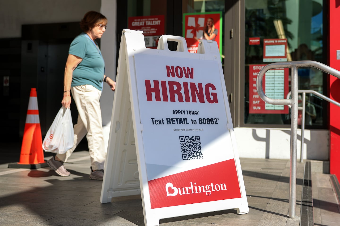 A hiring sign outside the entrance to a Burlington department store on Nov. 19 in Miami.