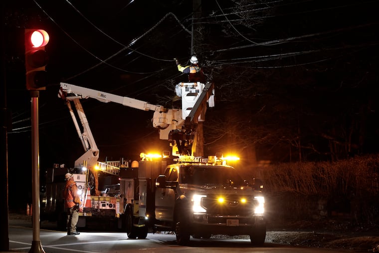 PECO crews work to restore damaged power lines at Chestnut Hill Avenue near Germantown Avenue in Philadelphia on Sunday, Feb. 16, 2025. High winds felled a large tree and the adjacent power lines. High winds again caused outages on Friday into Saturday.