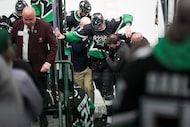 Dallas Stars defenseman Lian Bichsel (6) is helped from the ice after being injured during...