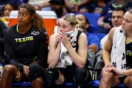 Dallas Wings guard Paige Bueckers (second from right) sits on the bench during the finals...