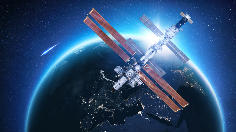 International Space Station above Europe, with a shooting star in the background.