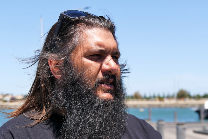 A man stands by the ocean