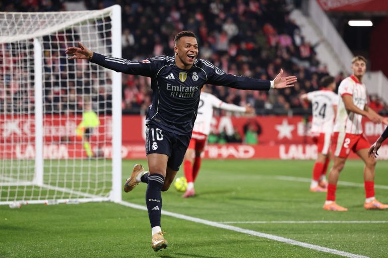 TOPSHOT - Real Madrid's French forward #10 Kylian Mbappe celebrates scoring the opening goal during the Spanish league football match between Girona FC and Real Madrid CF at Montilivi Stadium in Girona on November 30, 2025. (Photo by Josep LAGO / AFP)