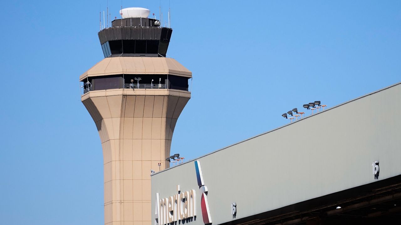 A control tower by an American Airlines hangar is shown at Dallas Fort Worth International Airport, Oct. 15, 2025, in DFW Airport, Texas. (AP Photo/Tony Gutierrez)