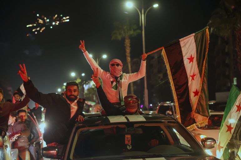 Syrians celebrate the first anniversary of the ousting of the Bashar Assad regime in Damascus, Syria, early Saturday, Dec. 6, 2025. (AP Photo/Ghaith Alsayed)